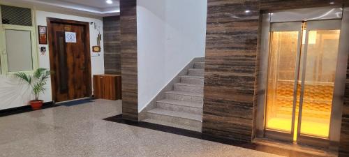 a lobby with a staircase and a glass door at Yogvan Luxury 1BHK Apartments Tapovan Rishikesh in Rishīkesh