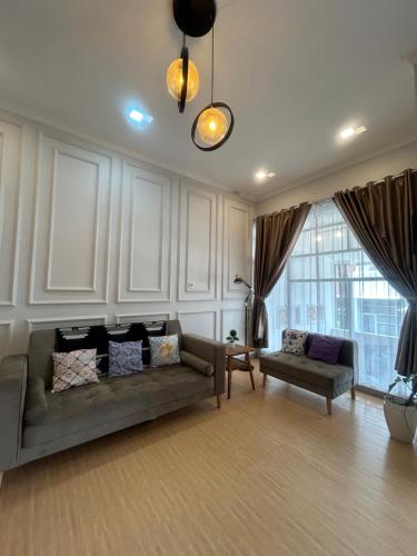 a living room with a couch and a table at Clamitan House in Padalarang