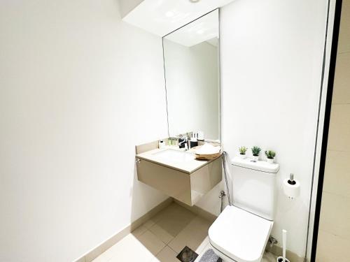 a bathroom with a white toilet and a mirror at Canal Front Haven 206WB12 in Abu Dhabi