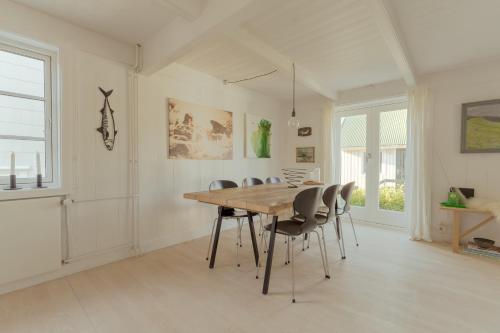 a dining room with a wooden table and chairs at Charming Retreat in the Heart of Tórshavn in Tórshavn