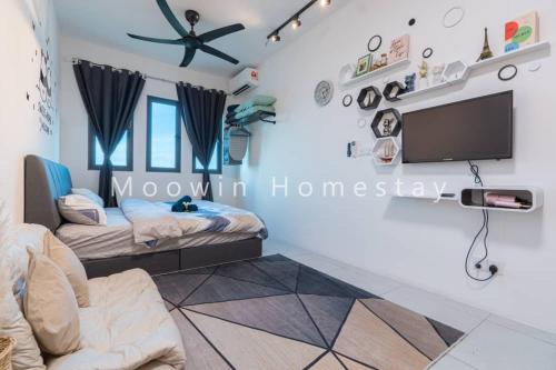 a room with two beds and a flat screen tv at Comfy Studio Room by Moowin in Perai