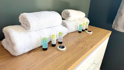 a counter with towels and toothbrushes in cups on it at Huge Family House - Free Parking - Central Harrogate in Harrogate