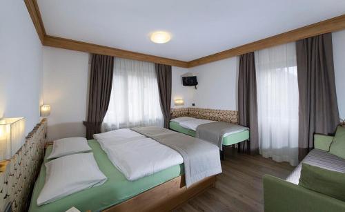 Postel nebo postele na pokoji v ubytování Hotel Aida