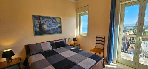 a bedroom with a bed and a large window at Miramare Apartment in Acquedolci