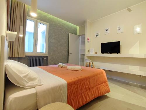 a bedroom with a bed with a teddy bear on it at Baccaro's home B&B in Brindisi