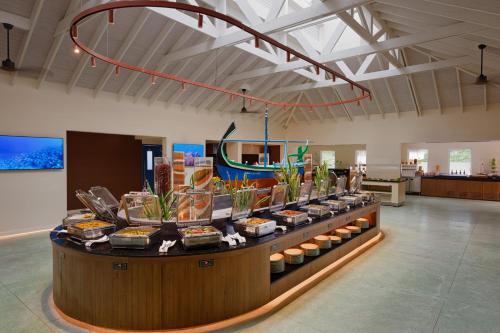 a food display in a room with food items at OBLU NATURE Helengeli-All-Inclusive with free Transfers in North Male Atoll