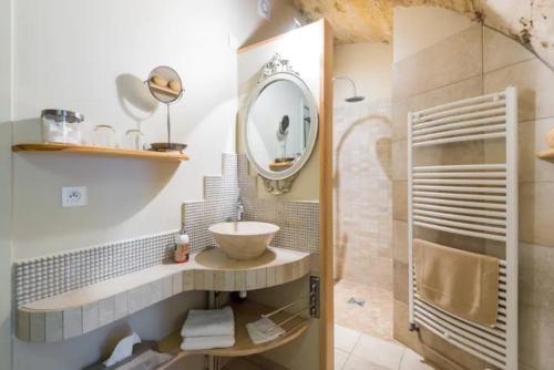 a bathroom with a sink and a mirror at Les Terrasses Dorées - Chambres d'hôtes de charme & Jacuzzi in Châtillon