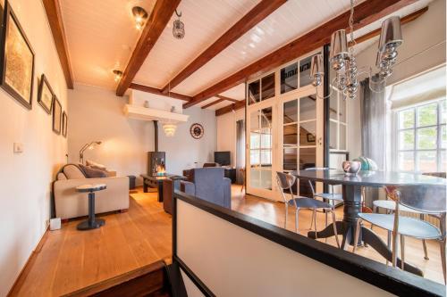 a living room and dining room with a table and chairs at Torenhuis Medemblik in Medemblik