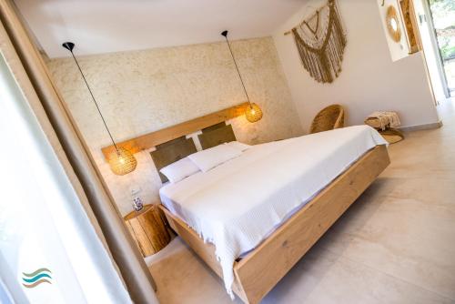 a bedroom with a large bed in a room at Plataria Seaside Resort in Plataria