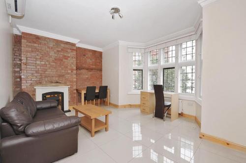 a living room with a couch and a fireplace at 1 bedroom apartment in Leicester Square in London