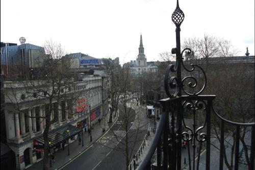 a view from a balcony of a city street with buildings at 1 bedroom apartment in Leicester Square in London