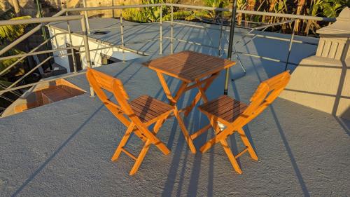 a wooden table and two chairs sitting on a boat at Banana Tree House in Ponta do Sol