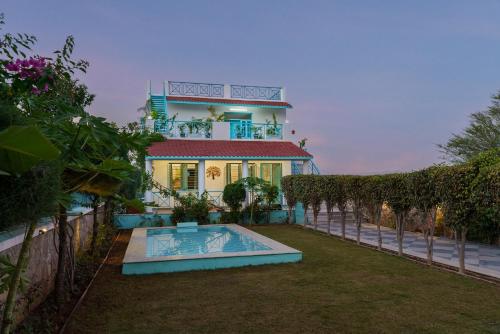 a house with a swimming pool in front of it at Thaharo 2 BHK Luxurious Villa in Udaipur in Thūr