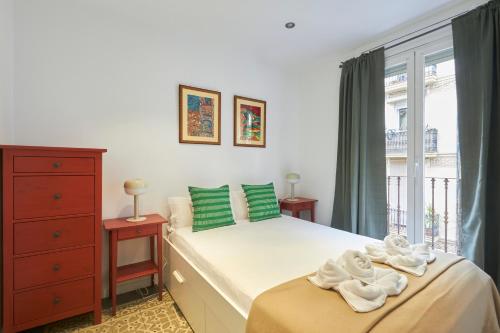 a bedroom with a bed with towels on it at 64 Apartment in a typical Barcelona's old building in Barcelona