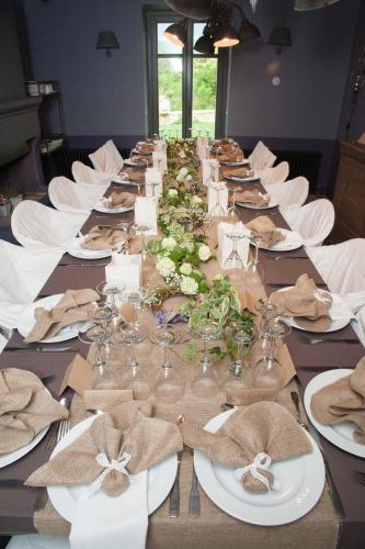 a long table with plates and glasses on it at "Apeiros Chora" Hotel, Zagori in Kato Pedina
