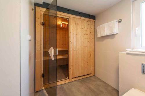 a shower with a glass door in a bathroom at House and Apt. in Mistelgau-Obernsees 26603 in Obernsees