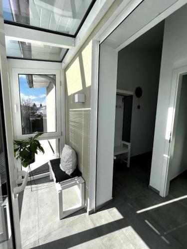 a room with a balcony with a chair and a window at Ferienwohnung Lorenz in Olching