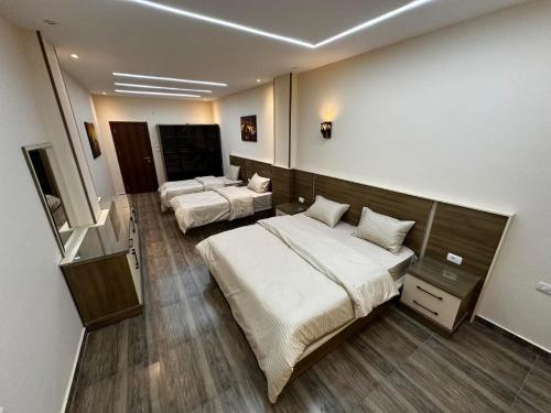 a room with two beds and a television in it at Narmer Pyramids View in Cairo