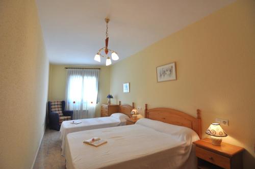 a hotel room with two beds and a window at RNET-Nautilus Roses Costa Brava in Roses