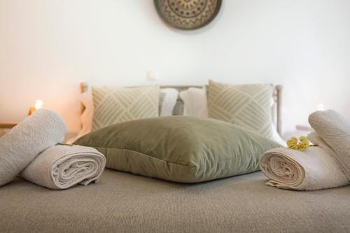 a bedroom with a bed with towels on it at Quercus Villa, Achilleion Palace, Corfu in Perama