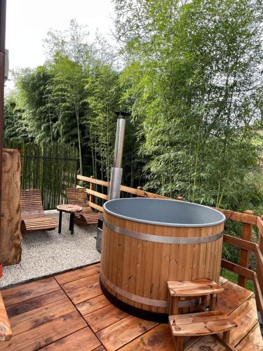 un bain à remous sur une terrasse en bois avec des bancs dans l'établissement Agriturismo Ai Masi, à Combai