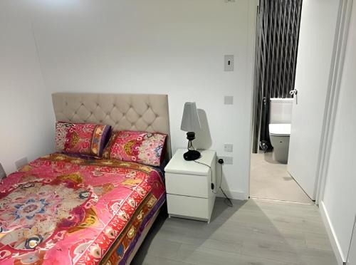 1 dormitorio con cama y mesita de noche con lámpara en OYO Stay Inn Elmbank Terrace en Aberdeen