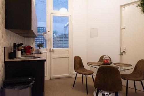 une cuisine avec une table et des chaises et une fenêtre dans l'établissement Apartment Arc de Triomphe Champs Elysées, à Paris