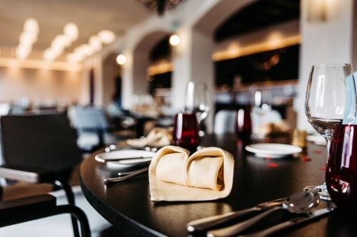 a wooden table with a heart shaped napkin on it at Seehotel am Kaiserstrand in Lochau