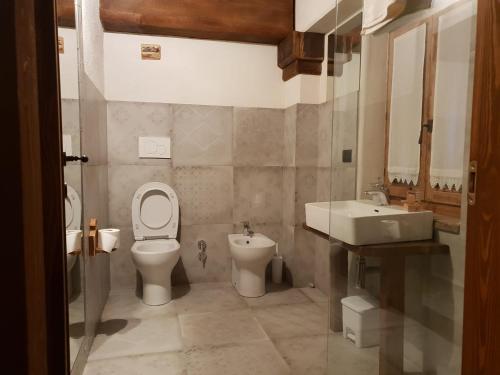 a bathroom with a toilet and a sink at Villaggio Borgomaira La Ginestra 