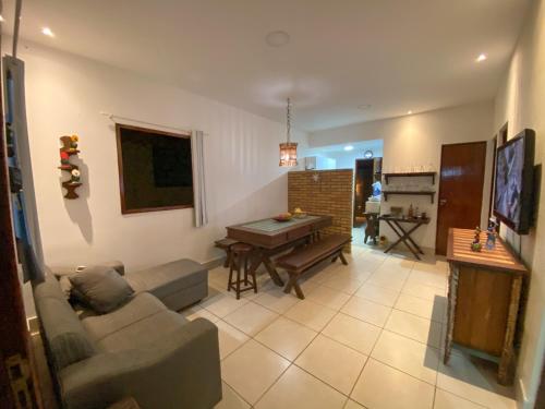 a living room with a couch and a table at Chalé Gravatá - Privê Jardim de Marie in Gravatá