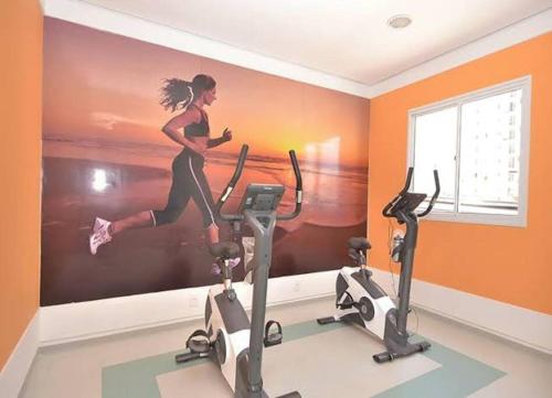 a mural of a woman running on a treadmill in a gym at Aeroporto de Guarulhos 1 in Guarulhos