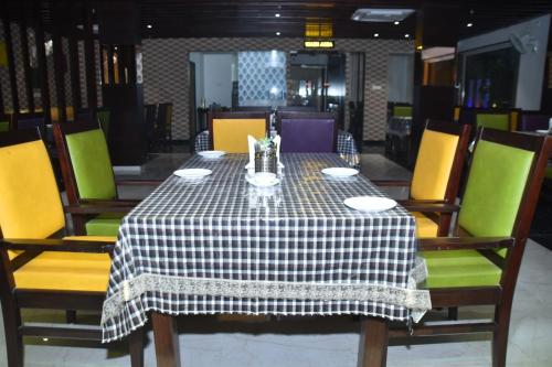 a table with a black and white checkered table cloth at Hotel Shivlok International By BookingCare in Satna