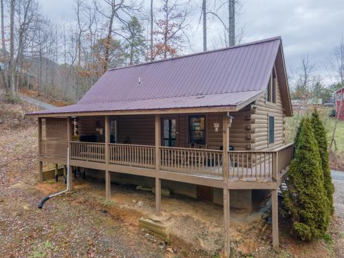 a cabin in the woods with a purple roof at Cozy Cabin Retreat: Tiny Trotter in Bryson City