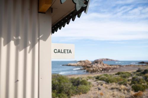 a building with a view of the ocean at Isla Leones Camps in Camarones