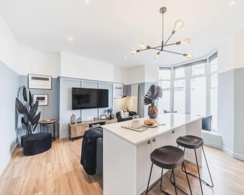 a kitchen with a counter and stools in a room at Newport's heart: Steps from shops & local charm! in Newport
