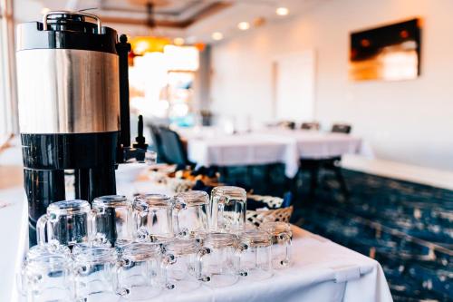a row of wine glasses on a table in a restaurant at Salem Waterfront Hotel & Suites in Salem