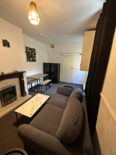 a living room with a couch and a fireplace at Clifton Street in Middlesbrough
