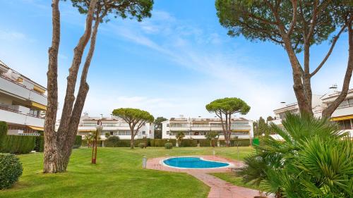 a courtyard with a swimming pool and trees at CP 13-A - Calella de Palafrugell in Calella de Palafrugell