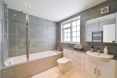 a bathroom with a tub and a toilet and a sink at £4 Million Covent Garden Apartment in London