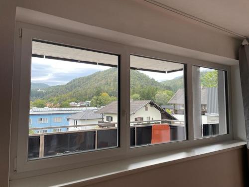 a window with three views of a town at Appartement Emat 13 in Telfs