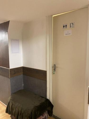 a room with a door leading to a room with a bed at Allaga City Center in Budapest