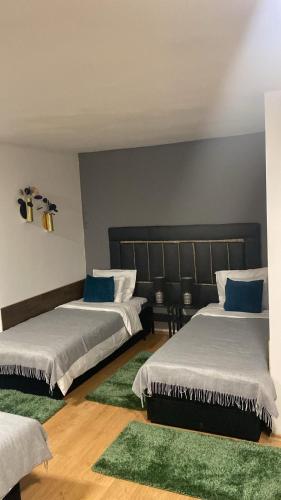 a bedroom with two beds with blue pillows at Allaga City Center in Budapest