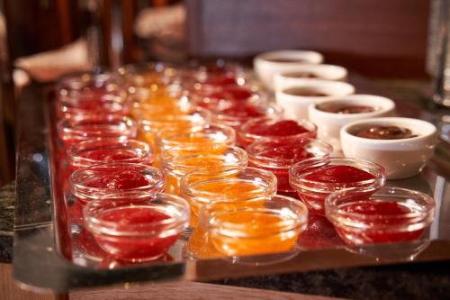 a long tray of glasses and bowls on a table at Jalta Boutique Hotel in Prague
