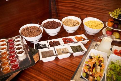 a table topped with bowls of different types of food at Jalta Boutique Hotel in Prague