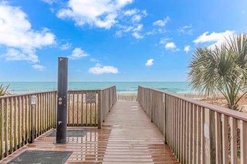 a wooden walkway to the beach with the ocean at Stunning Double Balcony- Oceanfront 2 Bedroom, 2 Bath- Anderson Ocean Club 905 in Myrtle Beach
