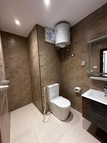 a bathroom with a toilet and a sink at Narmer Pyramids View in Cairo