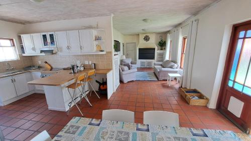 a kitchen and living room with a table and chairs at Ons Fontein in Langebaan