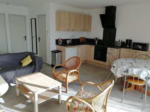 een woonkamer met een bank en een tafel en stoelen bij T3- vue mer - Plage 50 m in Martigues