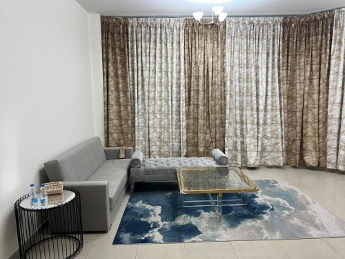 a living room with a couch and a table at F22R4 Small room attach bath at beach in Ajman 