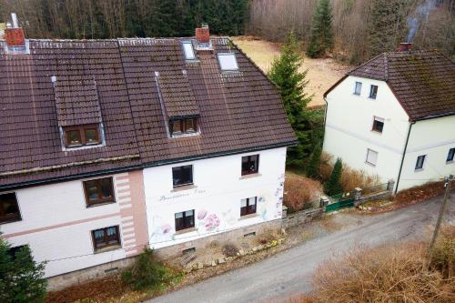 an aerial view of two white houses and a road at Buchhaus Vier - Erdgeschoss in Kirchenlamitz